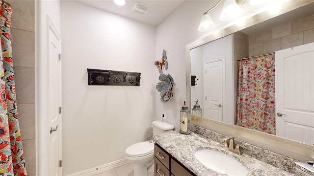 bathroom with tile patterned floors, vanity, and toilet