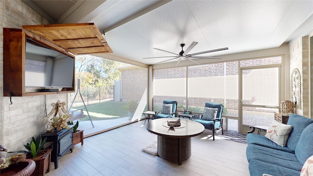 sunroom / solarium featuring ceiling fan