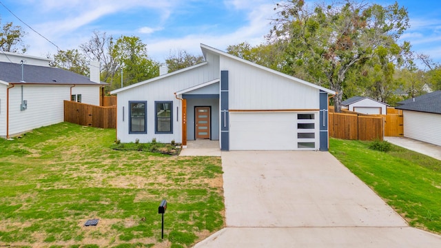 view of front of property featuring a garage and a front lawn