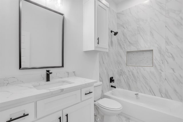 full bathroom with vanity, tiled shower / bath combo, and toilet