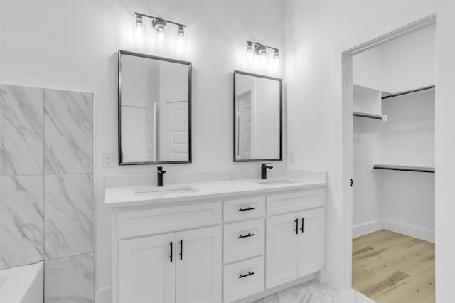 bathroom featuring a tub and vanity