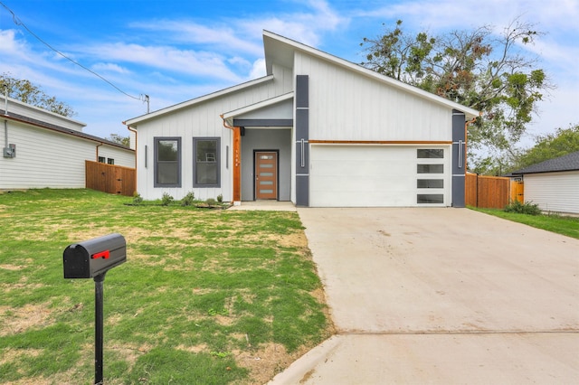 contemporary house with a garage and a front lawn