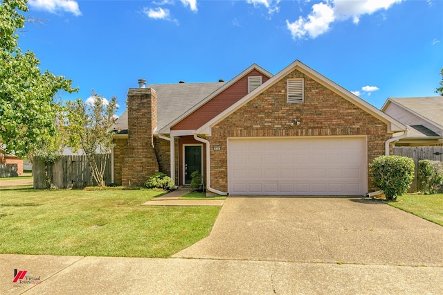 view of front of home featuring a front yard and a garage