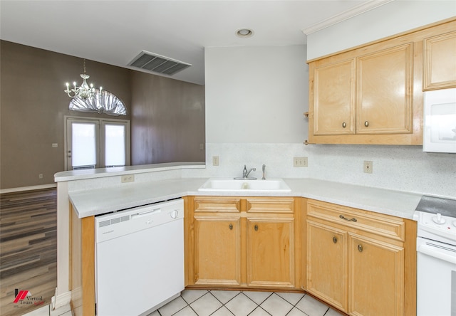 kitchen with white appliances, backsplash, an inviting chandelier, sink, and light hardwood / wood-style flooring