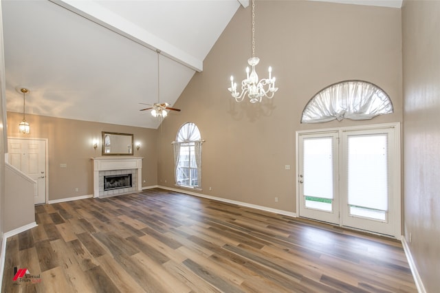 unfurnished living room featuring beamed ceiling, wood-type flooring, high vaulted ceiling, and a tiled fireplace