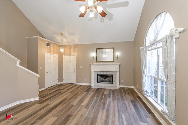 unfurnished living room with dark hardwood / wood-style floors, ceiling fan, a fireplace, and high vaulted ceiling