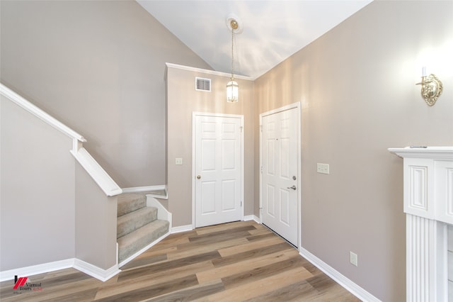 foyer entrance featuring high vaulted ceiling and hardwood / wood-style flooring