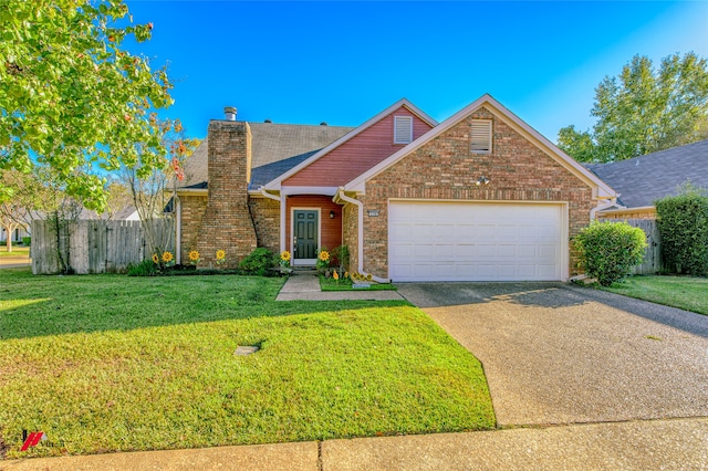 view of property with a garage and a front lawn