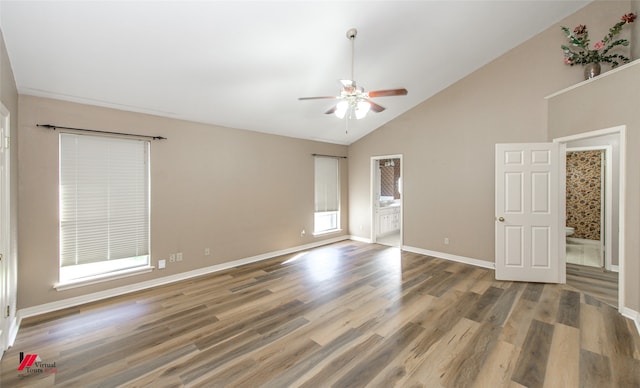 spare room with hardwood / wood-style flooring, high vaulted ceiling, and ceiling fan