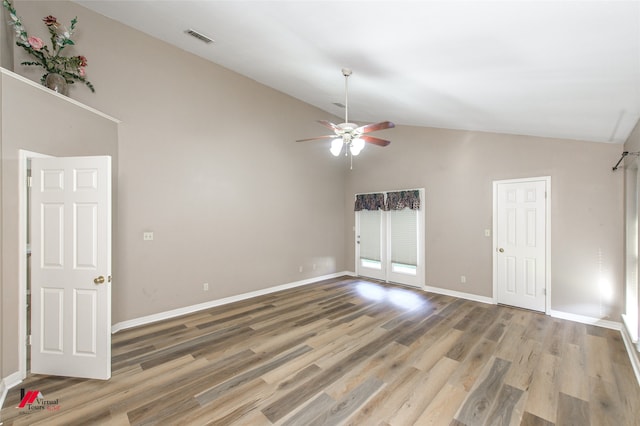 empty room featuring hardwood / wood-style floors, ceiling fan, and high vaulted ceiling