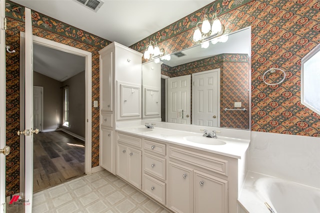 bathroom with a tub, vanity, lofted ceiling, and hardwood / wood-style flooring