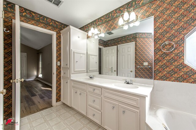 bathroom with a tub, vanity, lofted ceiling, and hardwood / wood-style flooring