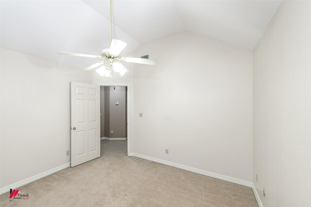 carpeted spare room featuring ceiling fan and lofted ceiling