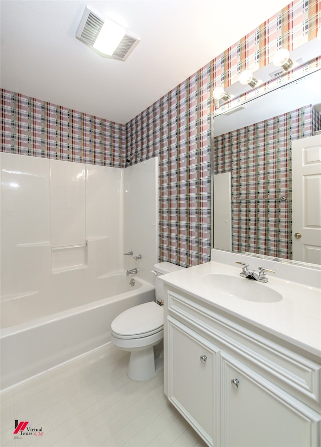 full bathroom with tile patterned flooring, vanity, shower / bathtub combination, and toilet