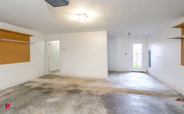 garage with electric panel and a garage door opener