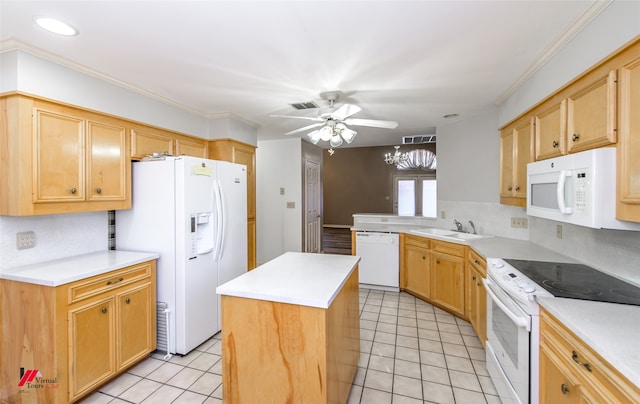 kitchen with white appliances, a center island, and ornamental molding