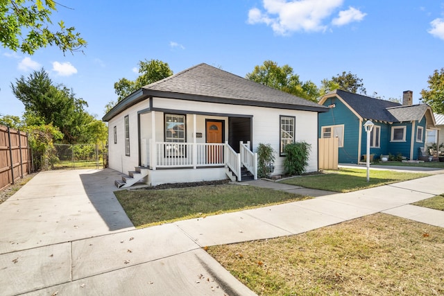 view of front of property with covered porch and a front yard