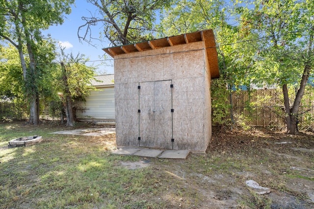 view of outdoor structure featuring an outdoor fire pit