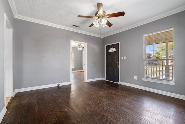 foyer entrance with a textured ceiling, dark hardwood / wood-style flooring, ceiling fan, and ornamental molding