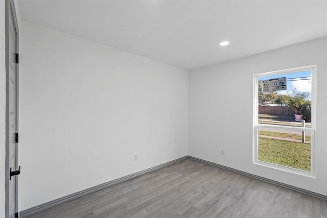 spare room with light hardwood / wood-style flooring