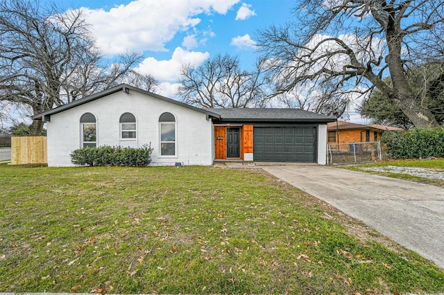 ranch-style home with a garage and a front yard