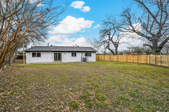 back of property featuring a lawn