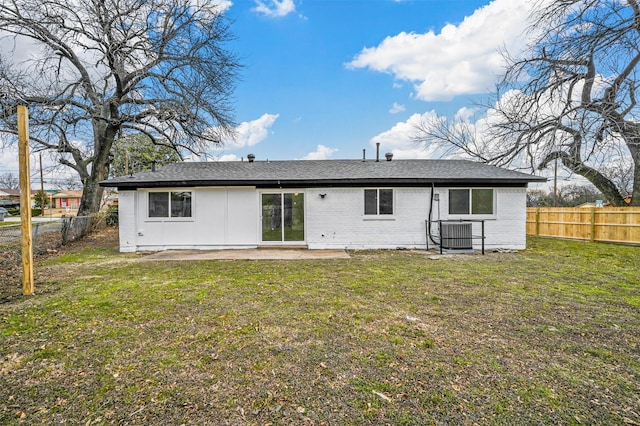 back of house with a yard and a patio