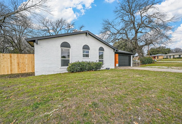 view of front of house with a garage and a front lawn