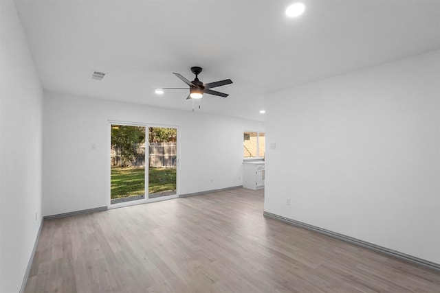 empty room with light hardwood / wood-style floors and ceiling fan