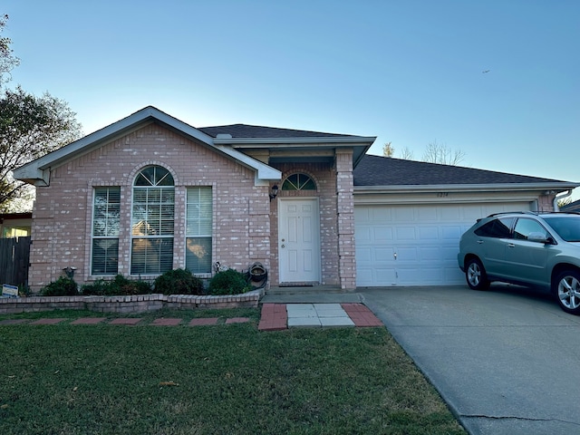 view of front of house with a garage and a front lawn