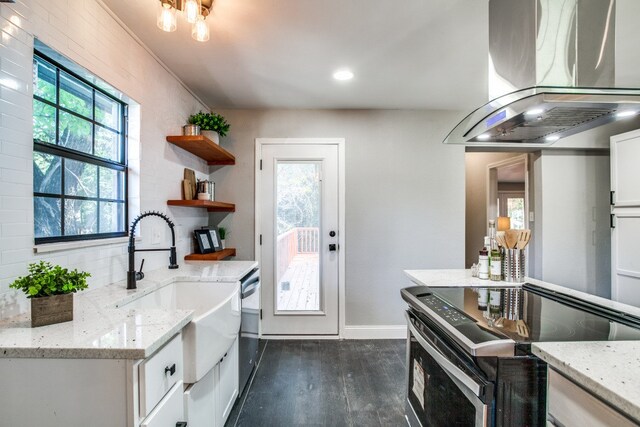 kitchen featuring island exhaust hood, appliances with stainless steel finishes, white cabinets, and light stone countertops