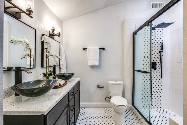 bathroom featuring a textured ceiling, an enclosed shower, vaulted ceiling, toilet, and vanity