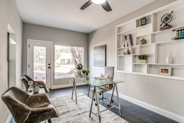 office area with built in shelves and ceiling fan