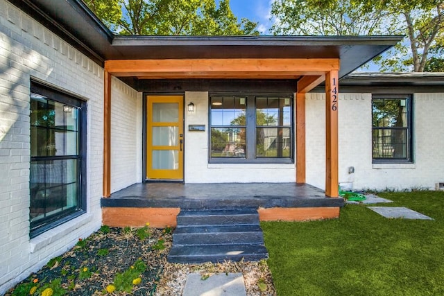 view of exterior entry with covered porch