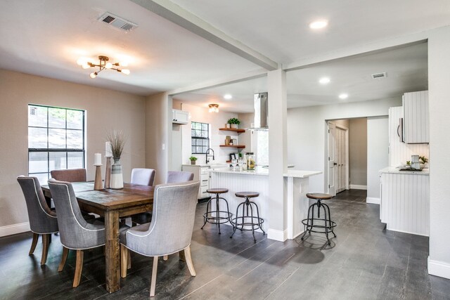 dining area featuring dark wood-type flooring and sink