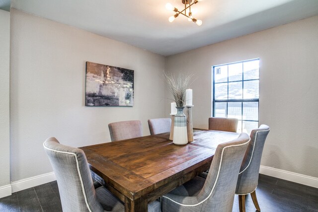 dining room featuring a notable chandelier and dark hardwood / wood-style floors