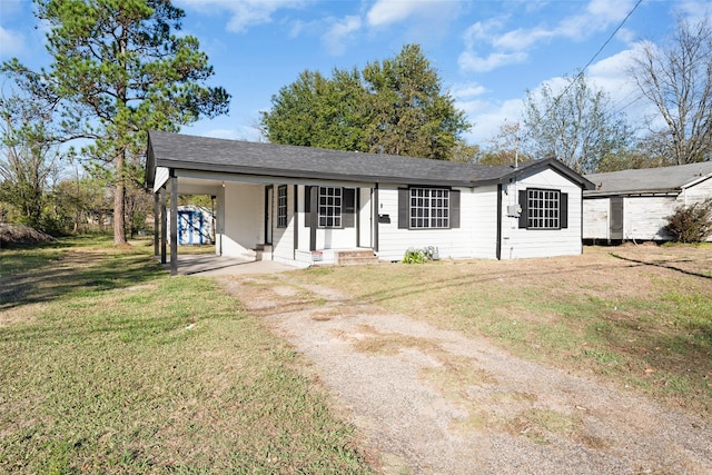 ranch-style house with a front yard and a carport