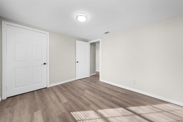 unfurnished bedroom featuring light wood-type flooring