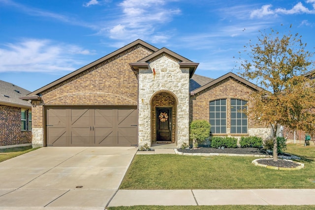 view of front of property with a front yard and a garage