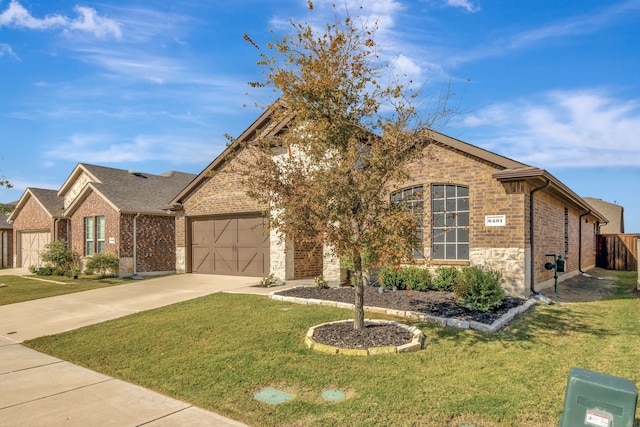 view of front of property featuring a garage and a front lawn