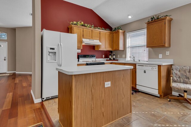 kitchen featuring a center island, sink, lofted ceiling, white appliances, and light wood-type flooring