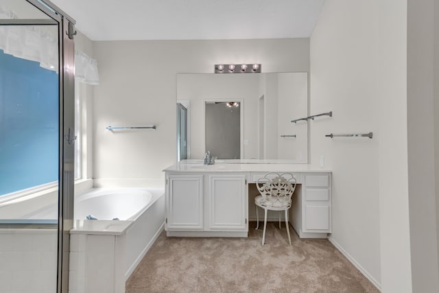 bathroom featuring a washtub and vanity