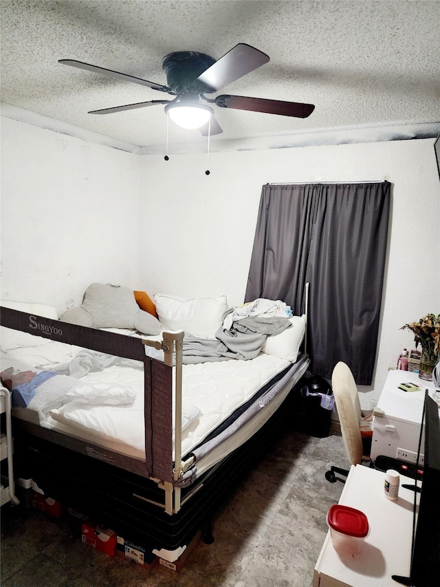 bedroom with a textured ceiling and ceiling fan