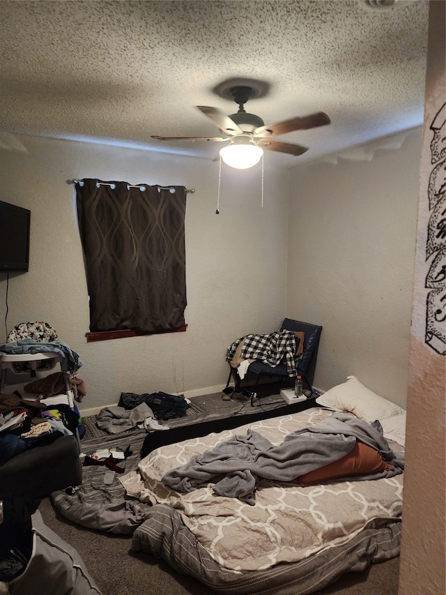 carpeted bedroom featuring ceiling fan and a textured ceiling