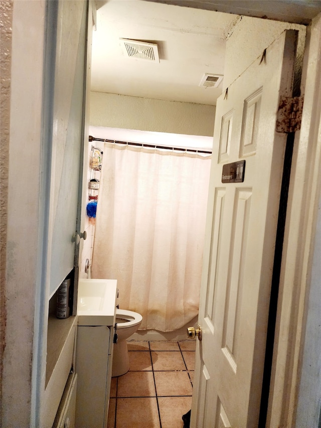 bathroom with tile patterned flooring, vanity, toilet, and a shower with curtain