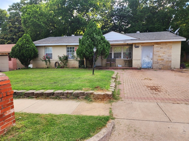 ranch-style home with covered porch and a front yard