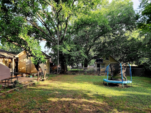 view of yard with a patio area and a trampoline