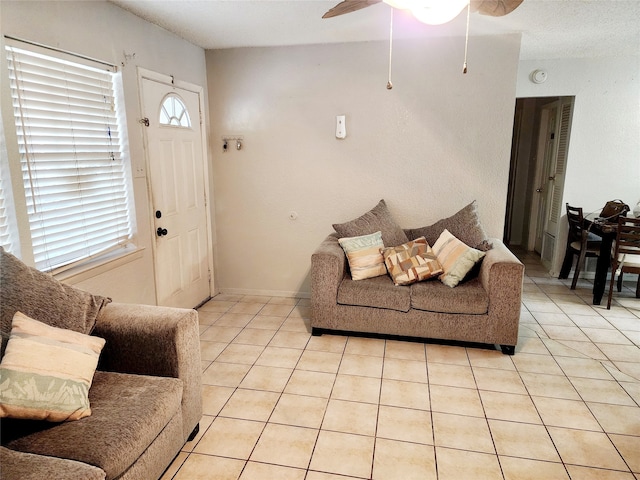 tiled living room featuring ceiling fan