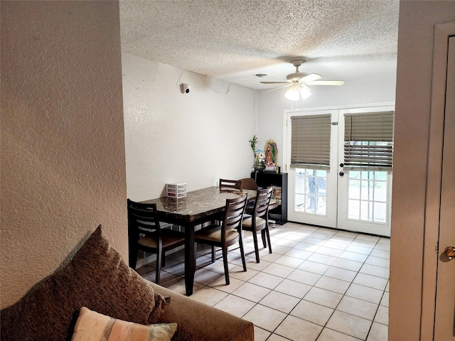 dining space with ceiling fan, light tile patterned floors, a textured ceiling, and french doors