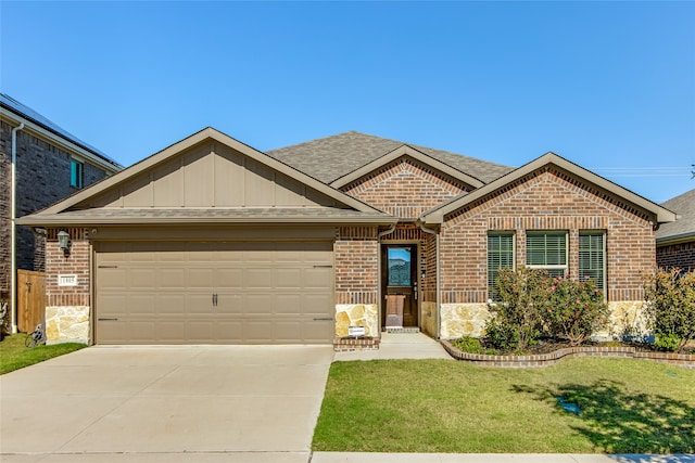 view of front facade with a front yard and a garage